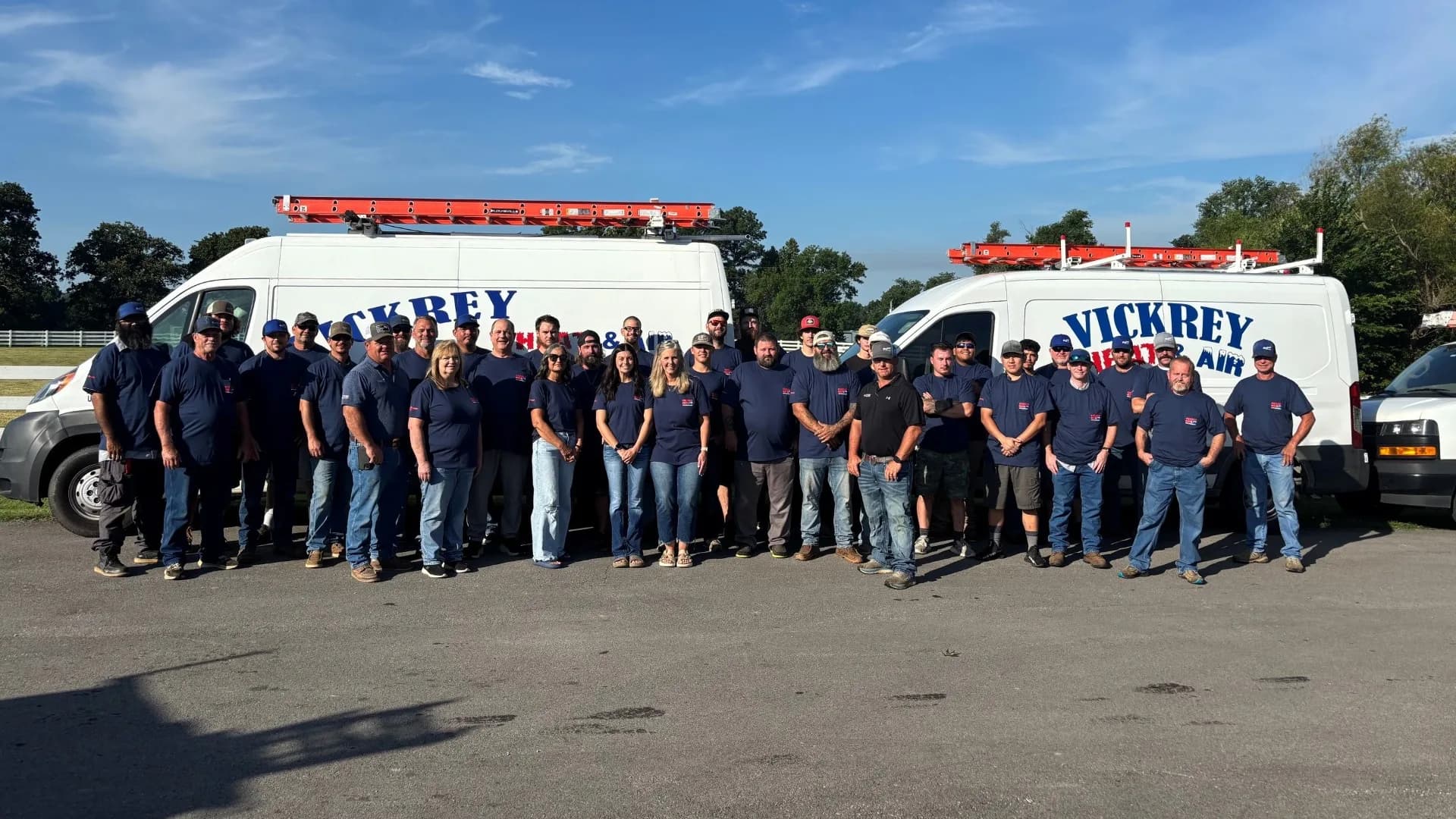 The Vickrey Heat & Air crew lined up in front of two company vans